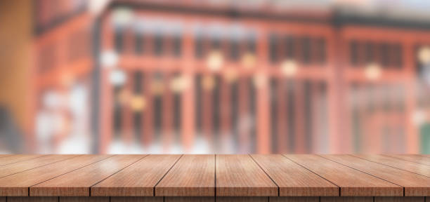 istock Empty wooden table top with lights bokeh on blur restaurant background. 1459991185
