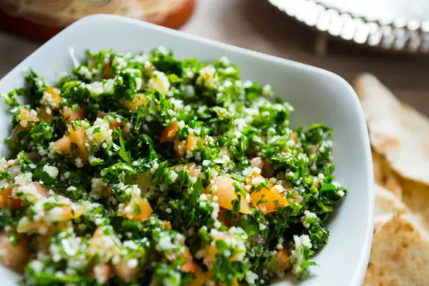 Tabuleh is a typical Shami or Levantine cuisine salad, consisting of chopped parsley, bulgur and other ingredients. It is one of the most traditional mezze appetizers, small dishes served together.