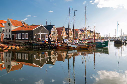 Urk Netherlands October 2020, Old historical harbor on a sunny day, Small town of Urk village with the beautiful colorful lighthouse at the harbor by the lake Ijsselmeer Netherlands Flevoland Europe