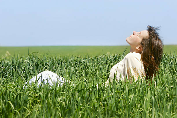 istock young girl relaxing in green grass 145999231