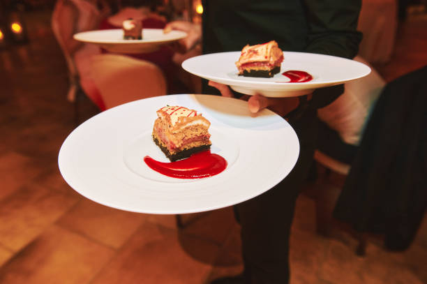 istock Waiter holding plates with cake on festive event, catering service 1459993431
