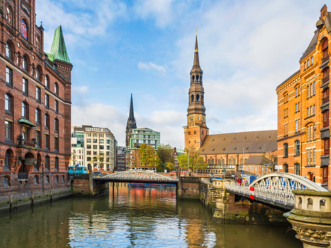 Speicherstadt, City of Warehouses and the Hauptkirche St Katharinen tower on the canal in  Hamburg, Germany