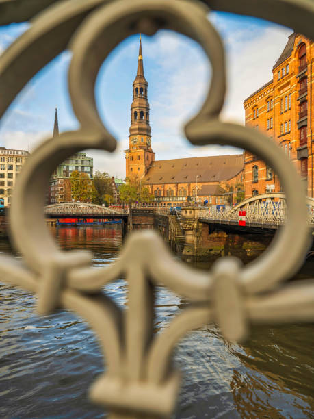 the Hauptkirche St Katharinen tower view through a fence frame in  Hamburg, Germany