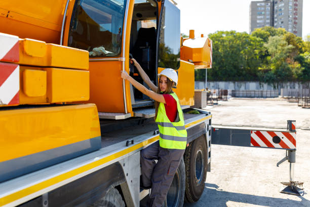 istock Portrait of a Young Female Construction Worker Entering a Construction Machine. 1459995826