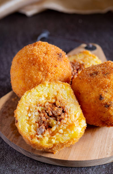 istock Fried stuffed Sicilian arancini with breadcrumbs crust 1459996991