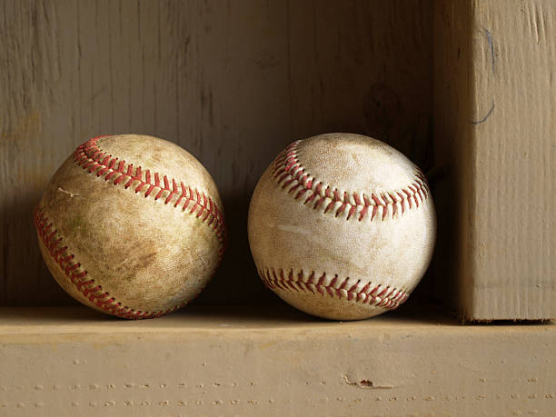 two baseball on a dugout shelf stock photo