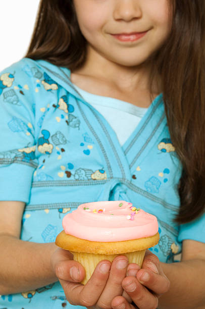 istock Young girl with pink cupcake. 145999933