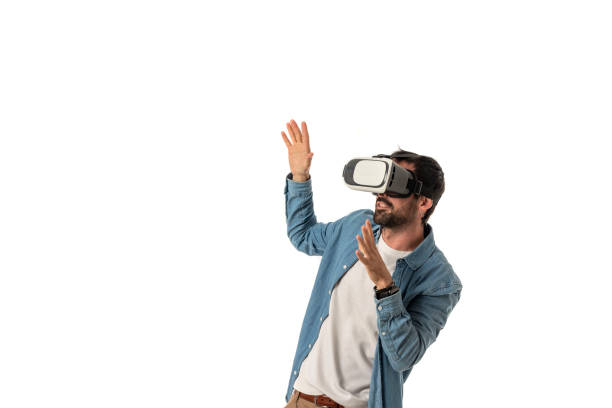 istock man wears VR glasses enjoying virtual reality isolated on white background, technology evolution concept 1459999738