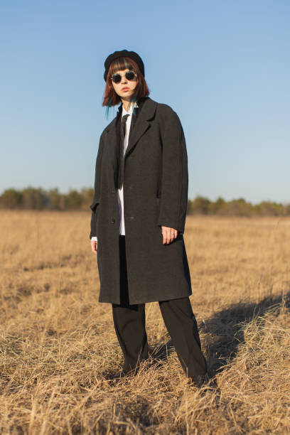 istock Redhead girl in black clothes outdoors. Gothic style 1460002380