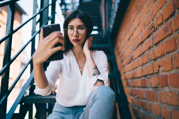istock Sensual woman making selfie in city 1460002455