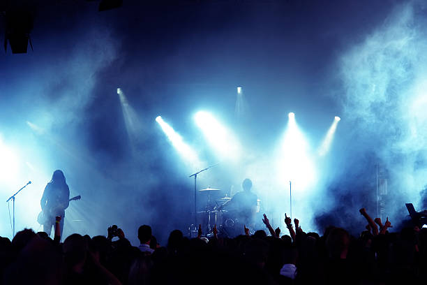 Crowd at a concert while a band is playing stock photo