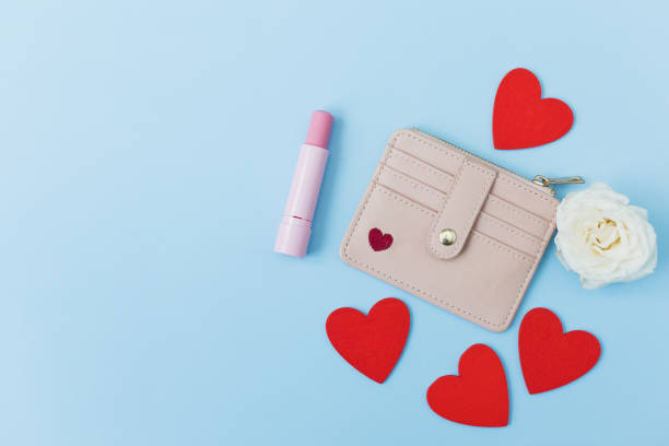 istock Pink wallet, lipstick on blue background 1460003677