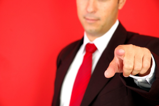 Business man pointing on the red background