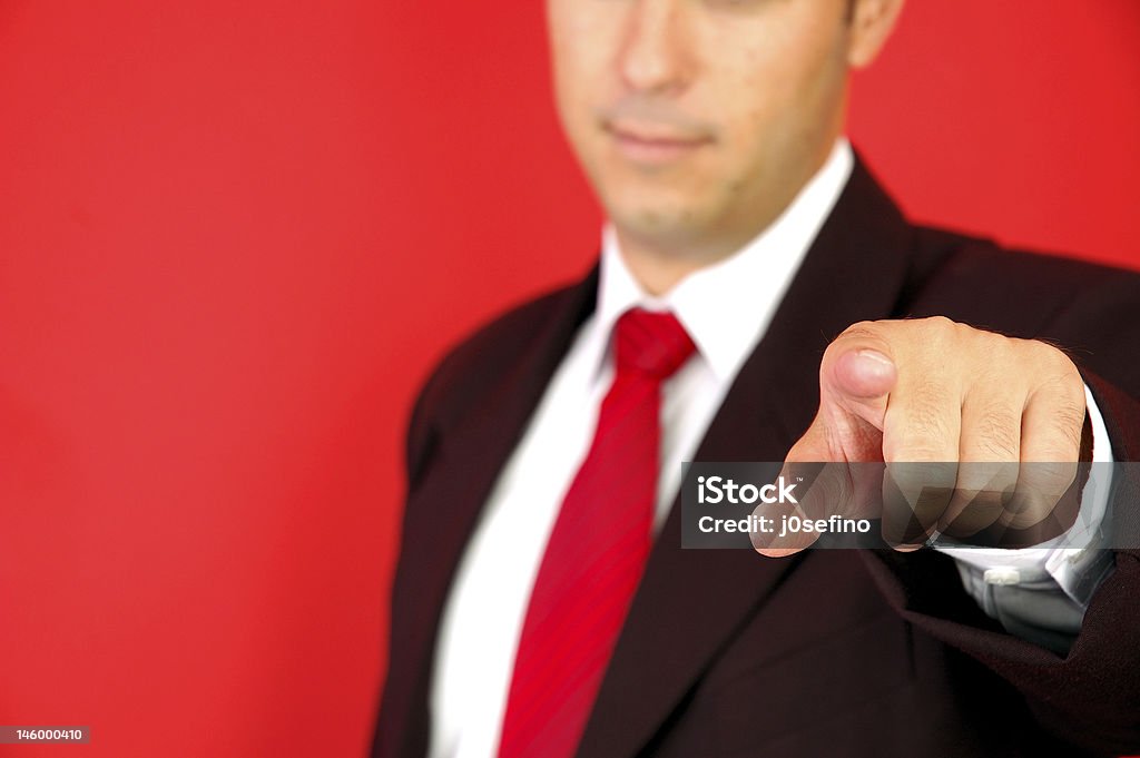 Businessman pointing with finger meaning I want you Business man pointing on the red background Looking At Camera Stock Photo