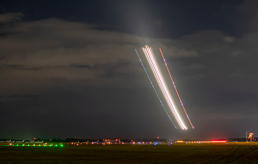 Long exposure of a plane taking off quickly from a runway at night in Norwich, Norfolk, UK