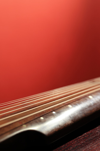 Electrical guitar headstock, machine heads and metal strings closeup. Electric guitar black and white color, detail. Music instruments. Concept international music day. Macrophotography. Soft focus