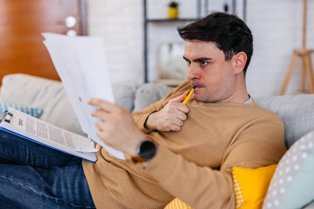 istock Young Man Checking His Finances At Home 1460005628