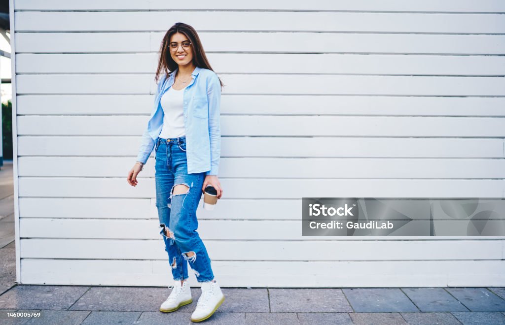 Free Photo  Young pretty hipster woman posing on the street near