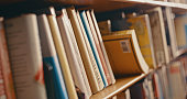 istock Library, research and row of books on bookshelf for reading, knowledge and educational learning. University bookstore, information and zoom of shelves with textbook, academic journal or literature 1460007248