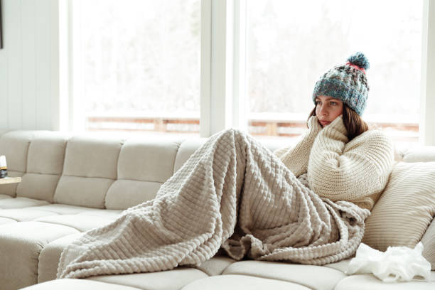 istock Female shiver at freezing flat in warm clothes 1460009533