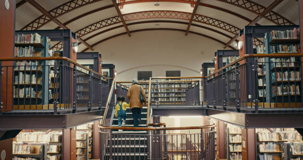 Stack of books ascending staircase  circular window revealing city view. 3d