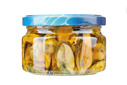 Glass jar with conserved mussels isolated on the white background. File contains clipping path.