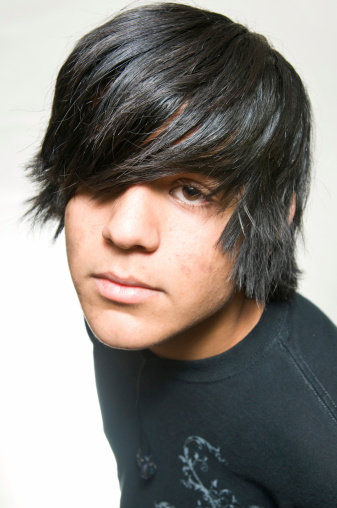 Teen portrait dressed in black on white background close up black hair