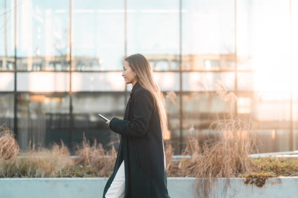 istock Businesswoman walking and texting 1460014604