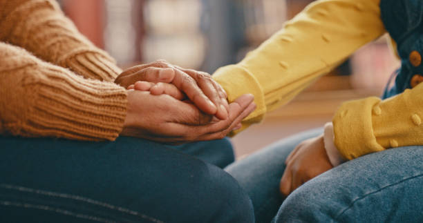 Hands, love and care touching in support, trust or unity for community, compassion or understanding. People holding hands in respect for loss, affection or passion for listening, talk or time stock photo