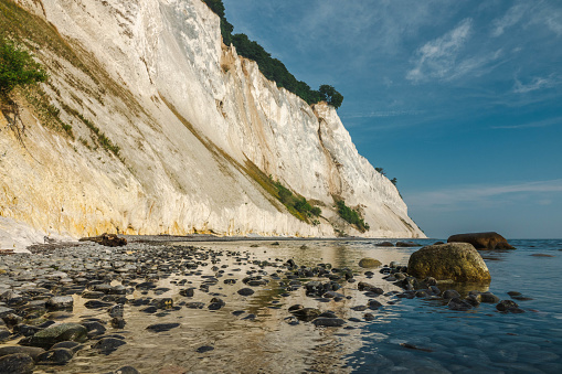 Chalk cliffs of Etretat (Normandy France) on a sunny day in summer, reflection in water