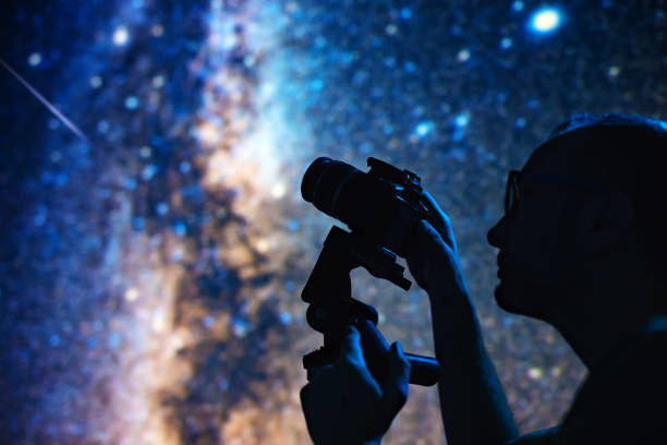 istock Astronomer photographing Milky Way night sky with a camera. 1460015985