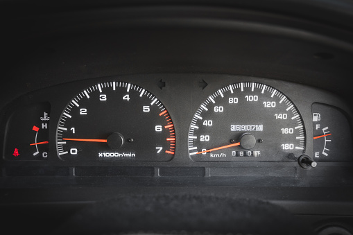 Front view of main dashboard with speedometer and tachometer in a used car.