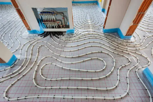 Photo of underfloor heating system in construction of new residential house