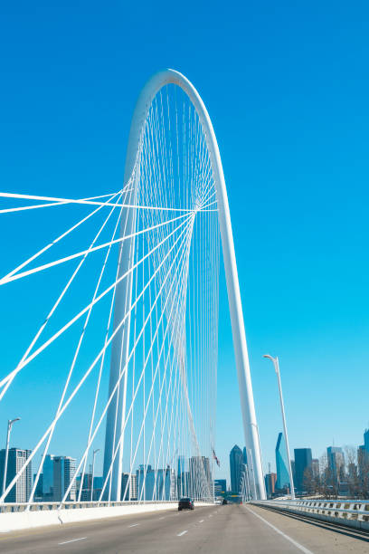 Margaret Hunt Hill Bridge with the clear blue sky and Dallas City downtown skyline in the background stock photo