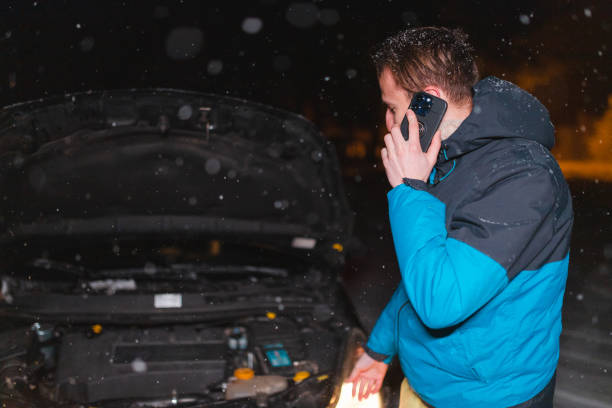 istock Young man's car stuck in the snow at night 1460019218