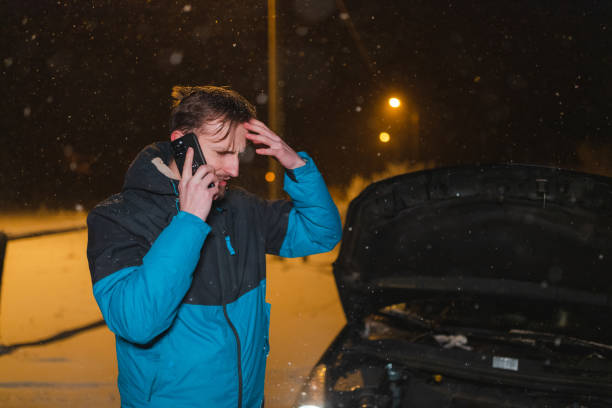 istock Stressed young man calling for help because his car is stuck in the snow 1460020260