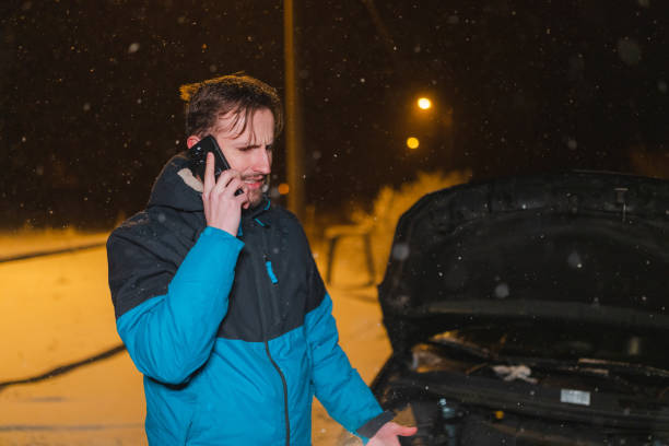 istock Stressed young man calling for help because his car is stuck in the snow 1460020271