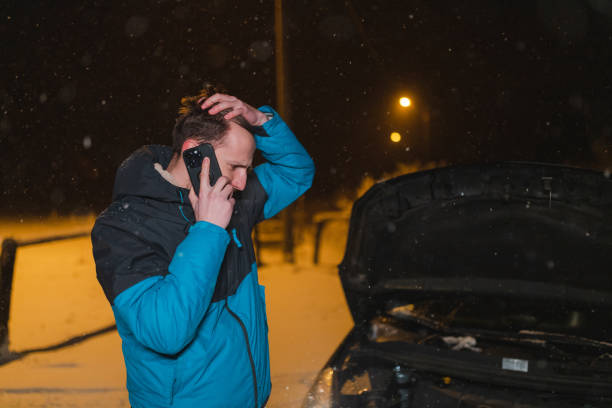 istock Stressed young man calling for help because his car is stuck in the snow 1460020278