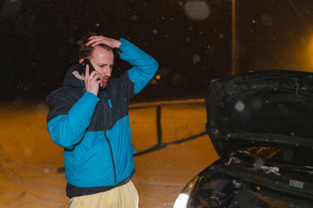 istock Stressed young man calling for help because his car is stuck in the snow 1460020328