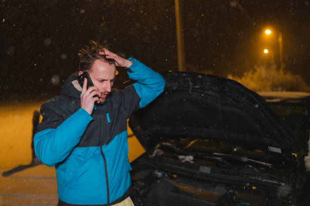 istock Stressed young man calling for help because his car is stuck in the snow 1460020329