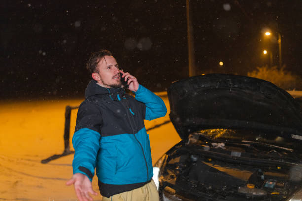 istock Young man's car stuck in the snow 1460020350