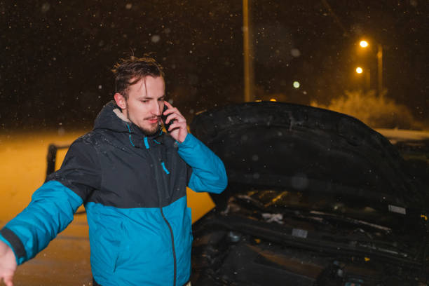 istock Stressed young man calling for help because his car is stuck in the snow 1460020351