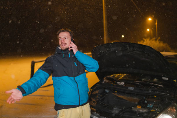 istock Young man's car stuck in the snow 1460020366