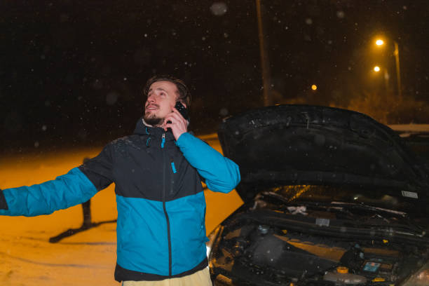 istock Young man's car stuck in the snow 1460020371