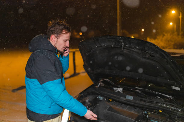istock Young man's car stuck in the snow 1460020382