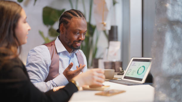 istock Multi-ethnic business people working together on digital tablet in cafe 1460022838