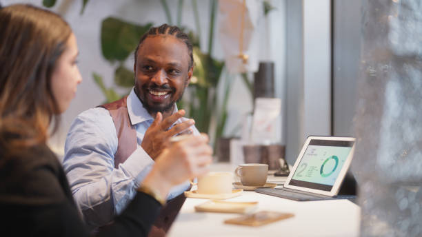 istock Multi-ethnic business people working together on digital tablet in cafe 1460023306