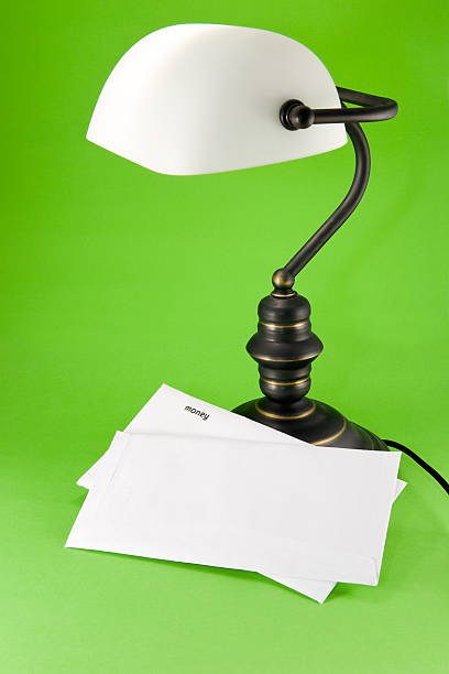 Lamp on green background, with money letter stock photo