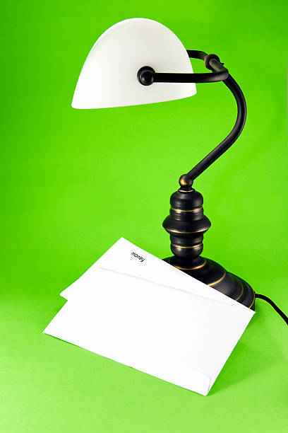 Lamp on green background, with money letter stock photo