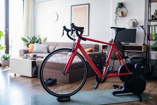 Red bicycle simulator set at home.